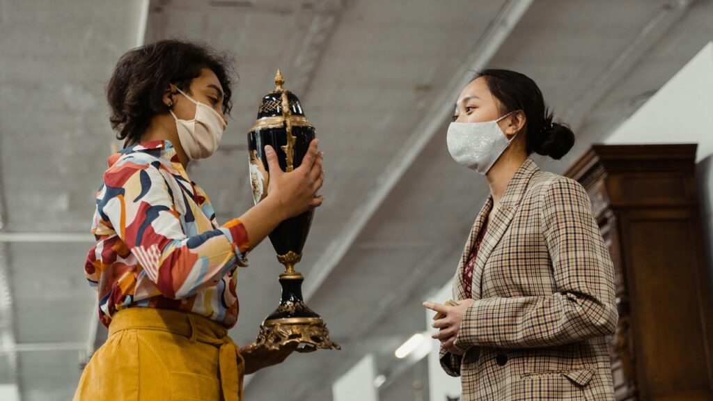 Woman having an expert appraisal of an antique collectible