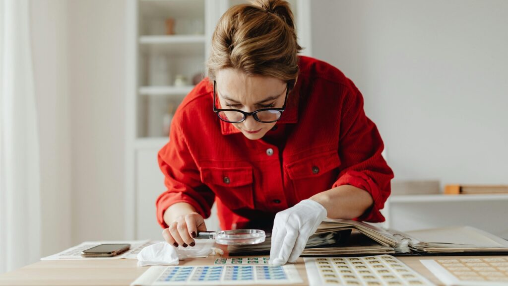Stamp Collector, magnifying glass, white gloves, inspection